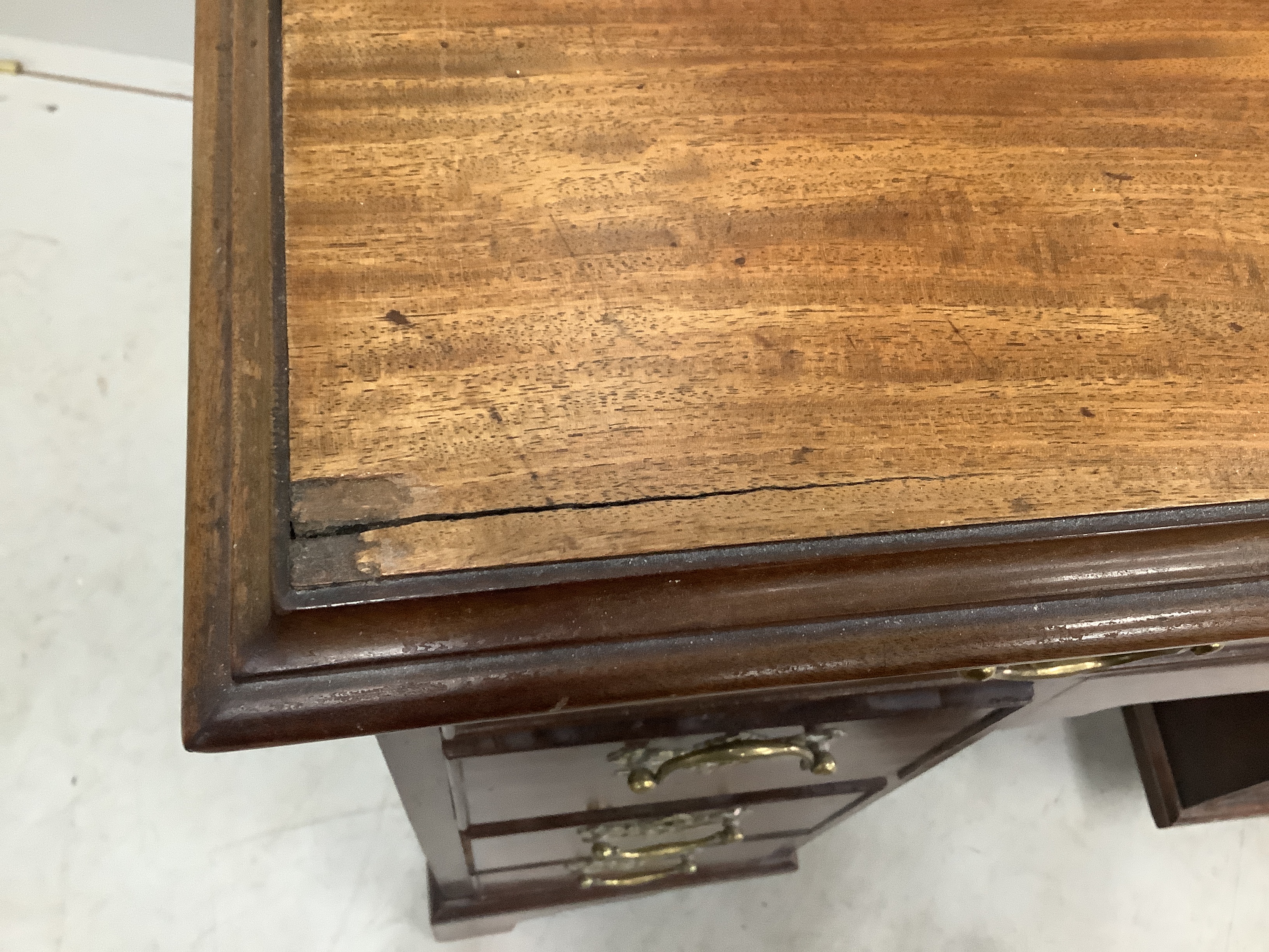 A George III and later mahogany kneehole desk with secretaire drawer, width 85cm, depth 52cm, height 92cm